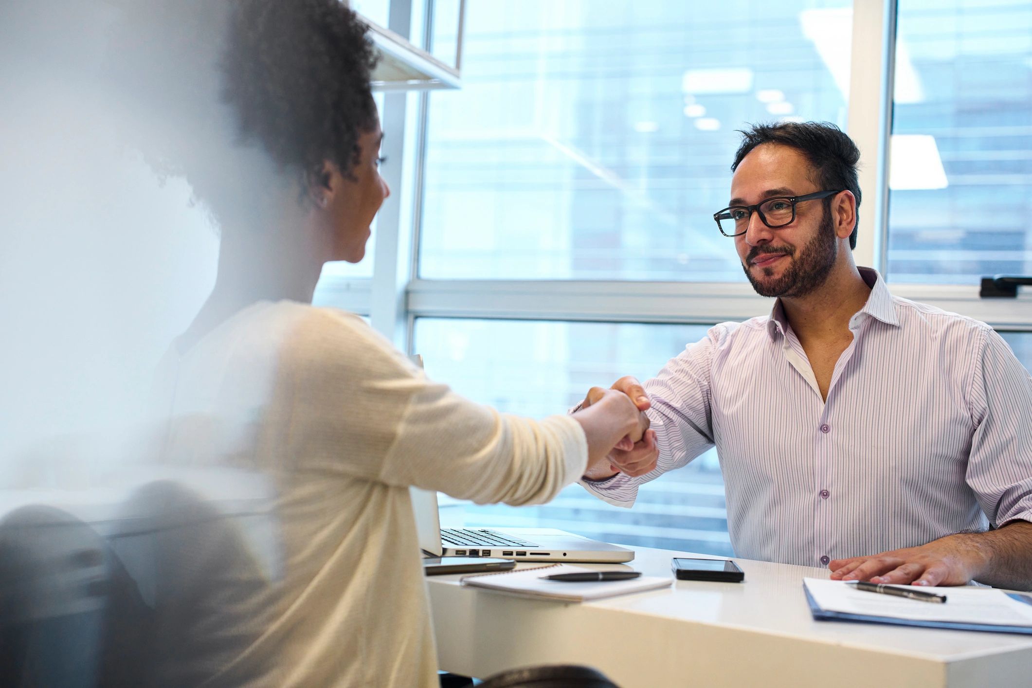 Professional interview handshake representing job search support