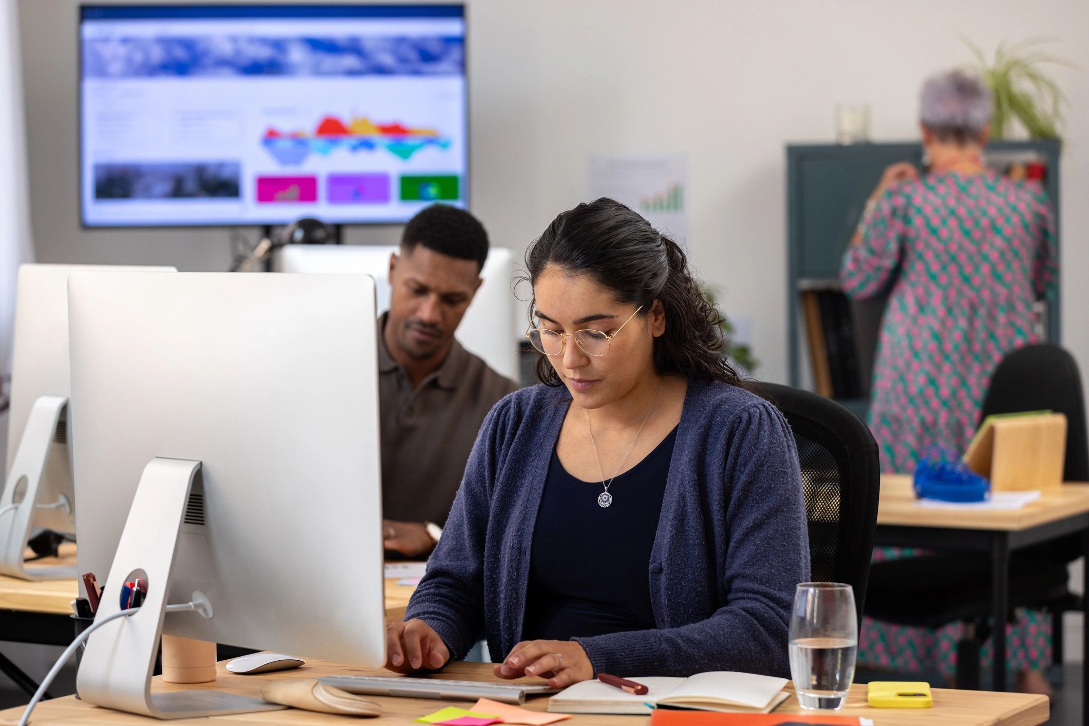 Professionals reviewing company hiring data in an office