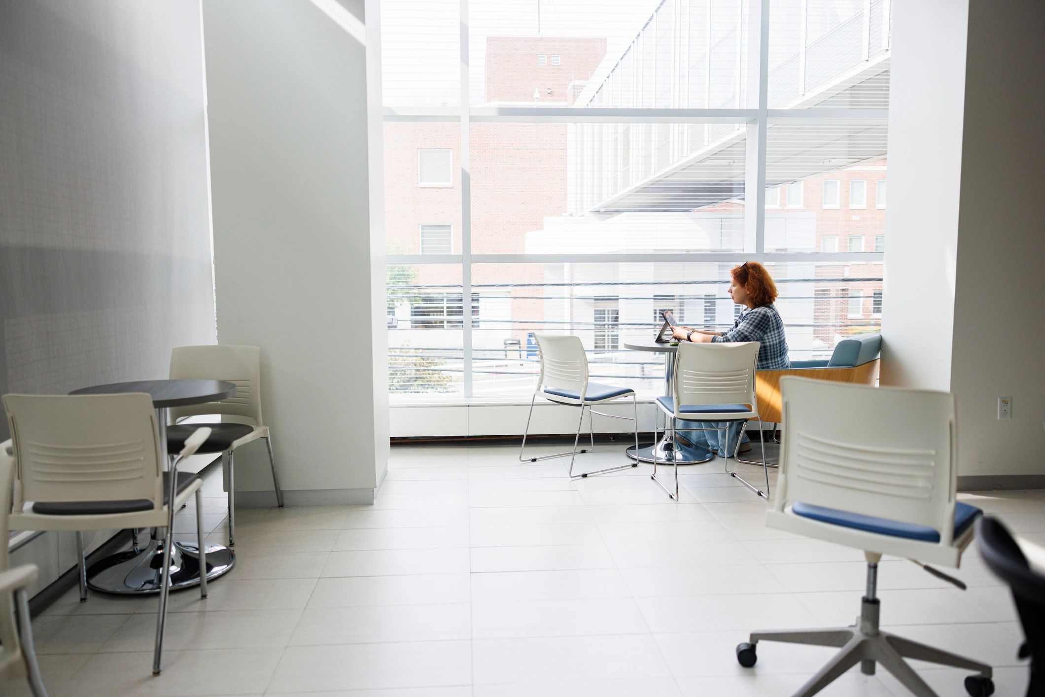 Professional working on laptop in a bright modern workspace